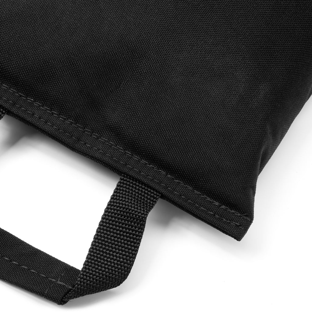 Close-up of a black bag with a strap on a white background