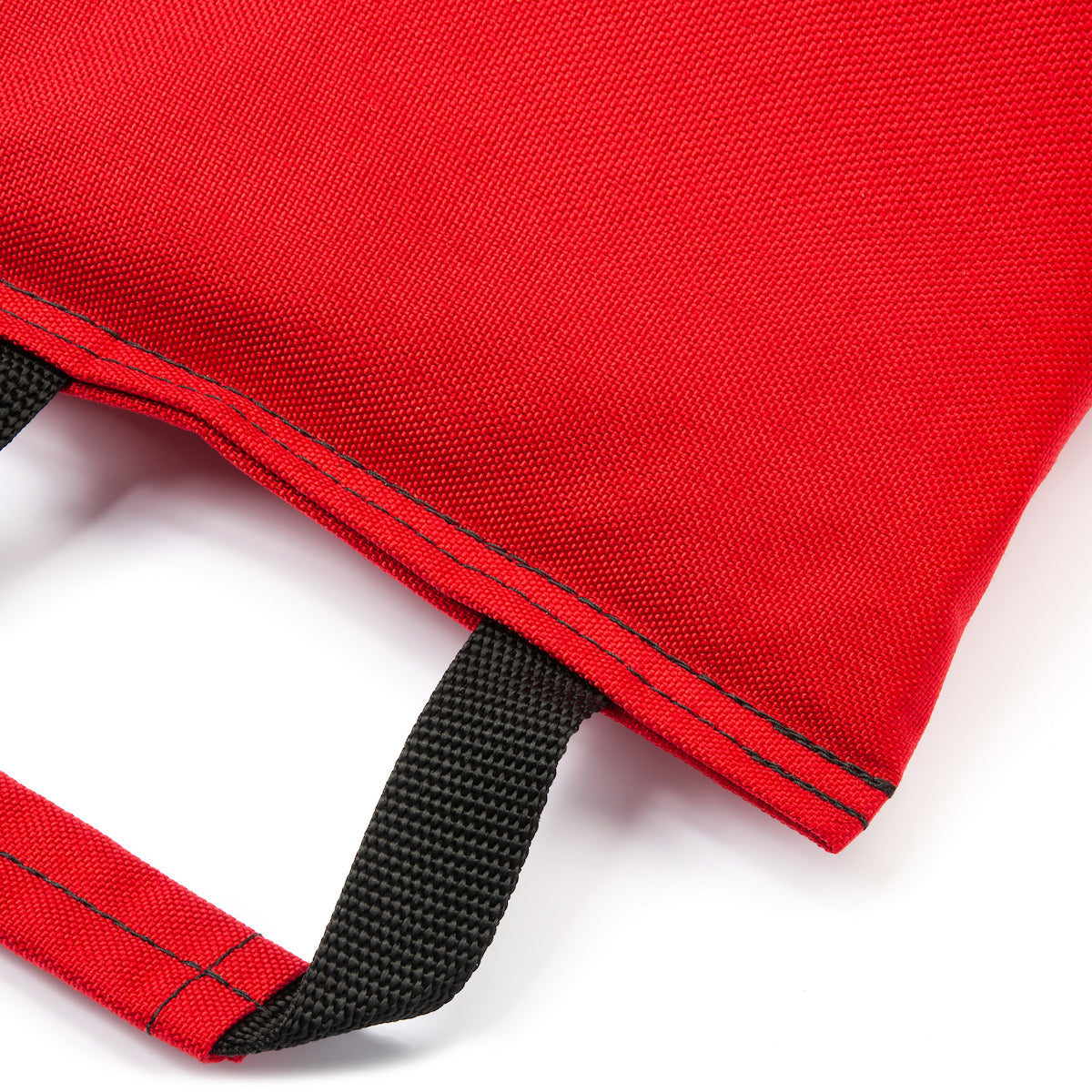 Close-up of a red bag with black straps on a white background