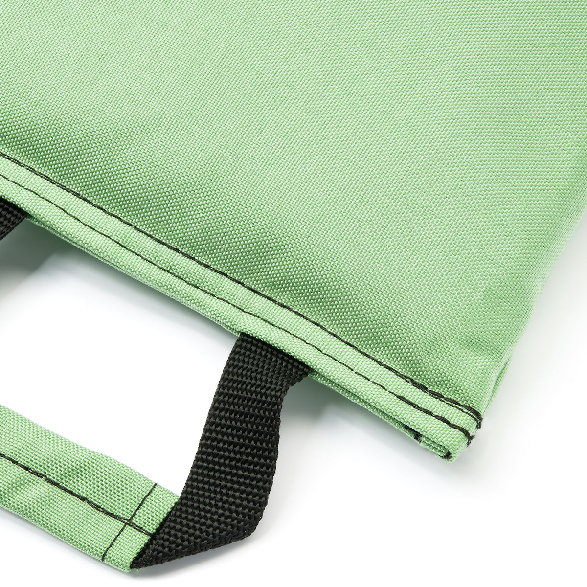 Close-up of a green fabric bag with a black strap on a white background