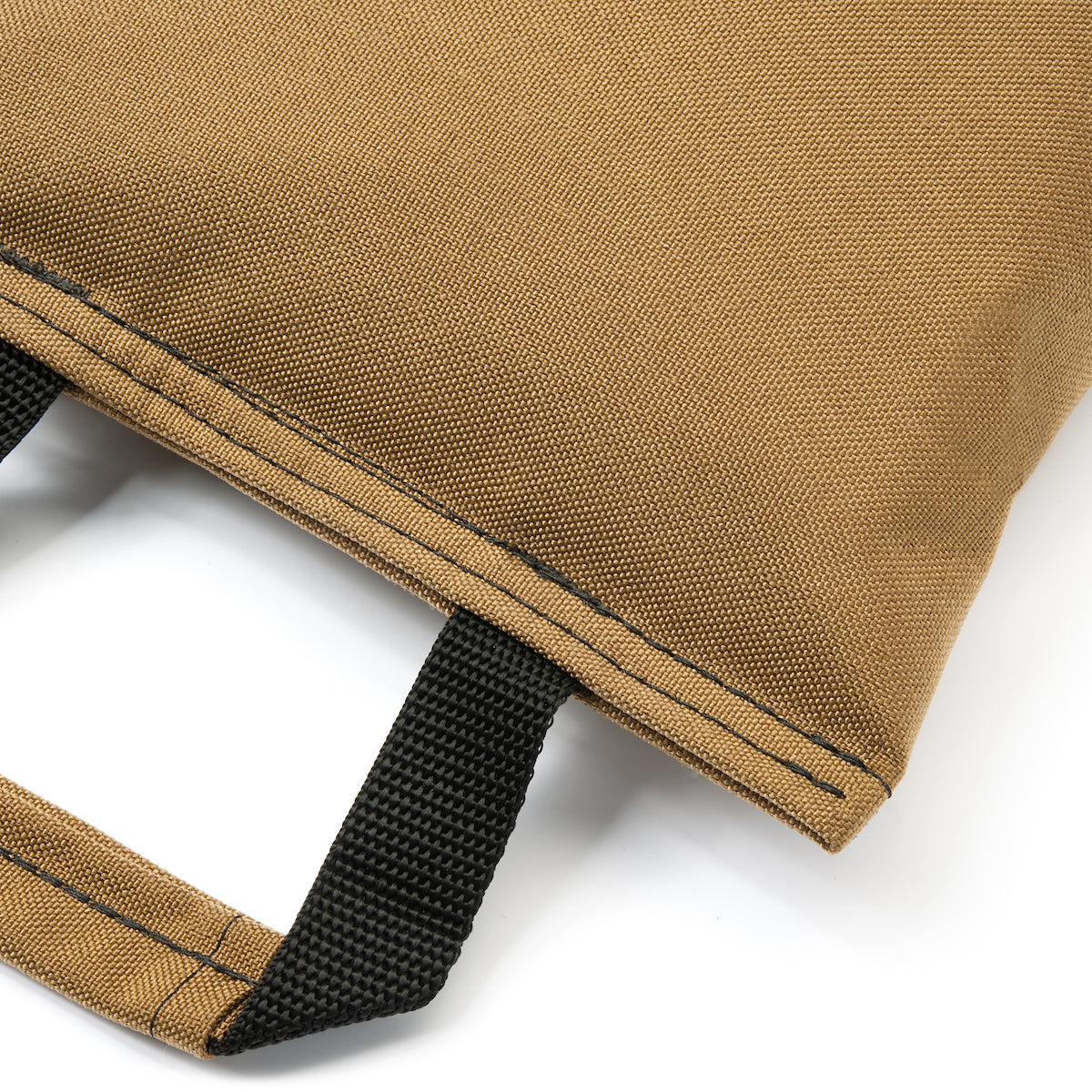 Close-up of a brown bag with a black strap on a white background