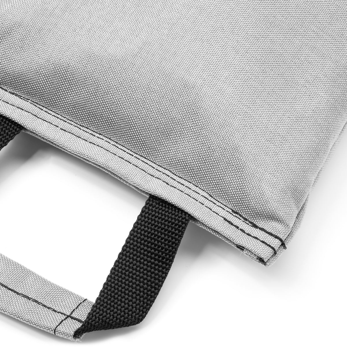 Close-up of a gray fabric with black stitching on a white background