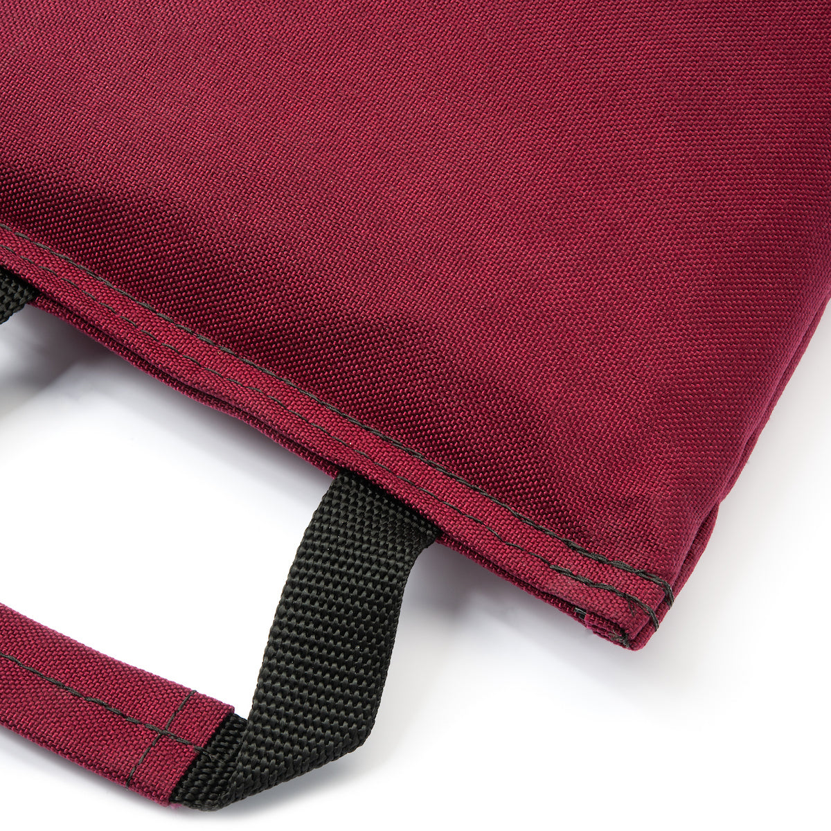 Close-up of a red bag with black strap on a white background