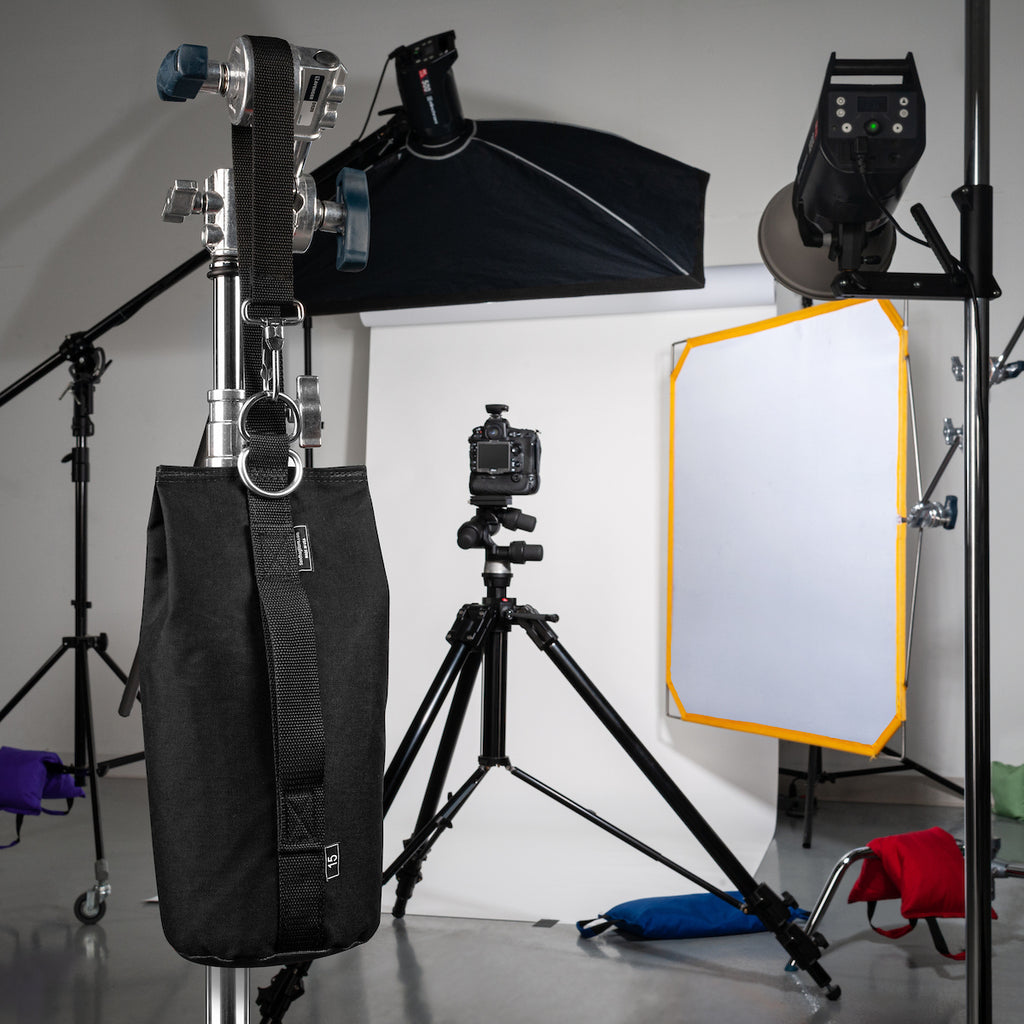 Photography studio setup with lighting equipment, camera, and backdrop.