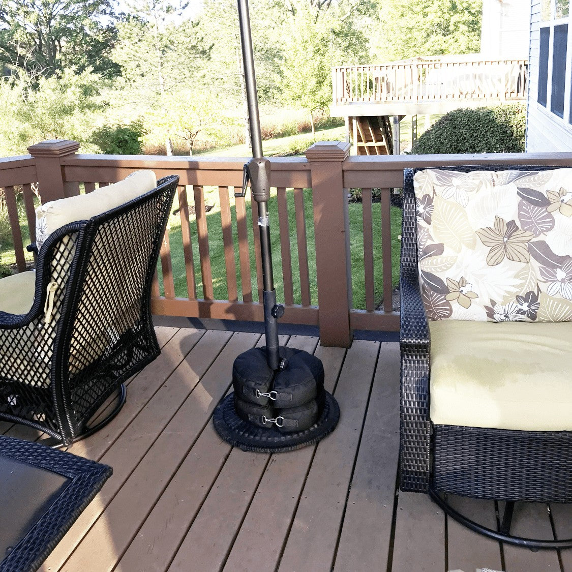 Circular Sandbags stacked on an outdoor umbrella base on a residential patio