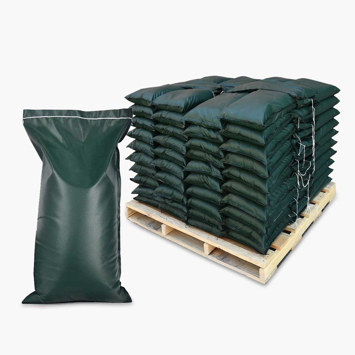 Stack of green seven year uv acrylic fabric sandbags on a wooden pallet with a single sandbag in front on a white background