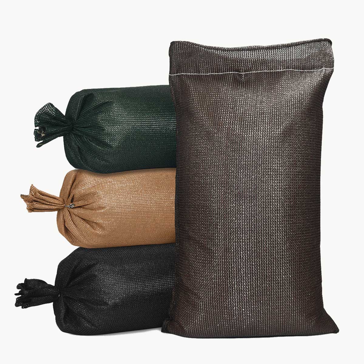 Four DuraBag 5 year UV sandbags in different colors on a white background