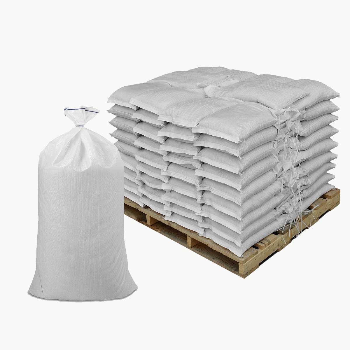 Stack of white sandbags on a wooden pallet with an additional white sandbag beside it on a white background.