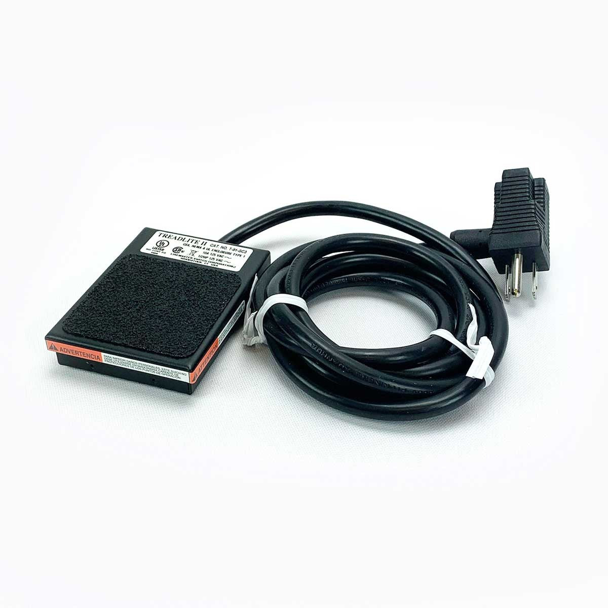 Treadlite II footswitch used for sandbag sewing heads with long black power cord coiled and tied on a white background